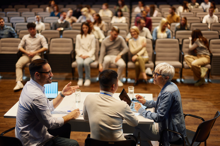 Decorative Group of people gathered around presenters