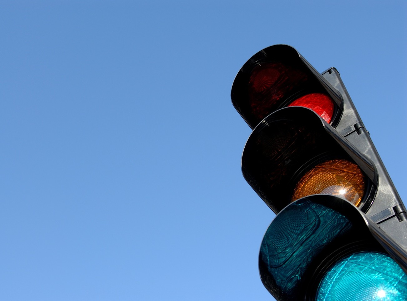 A traffic signal - red, yellow, and green lights
