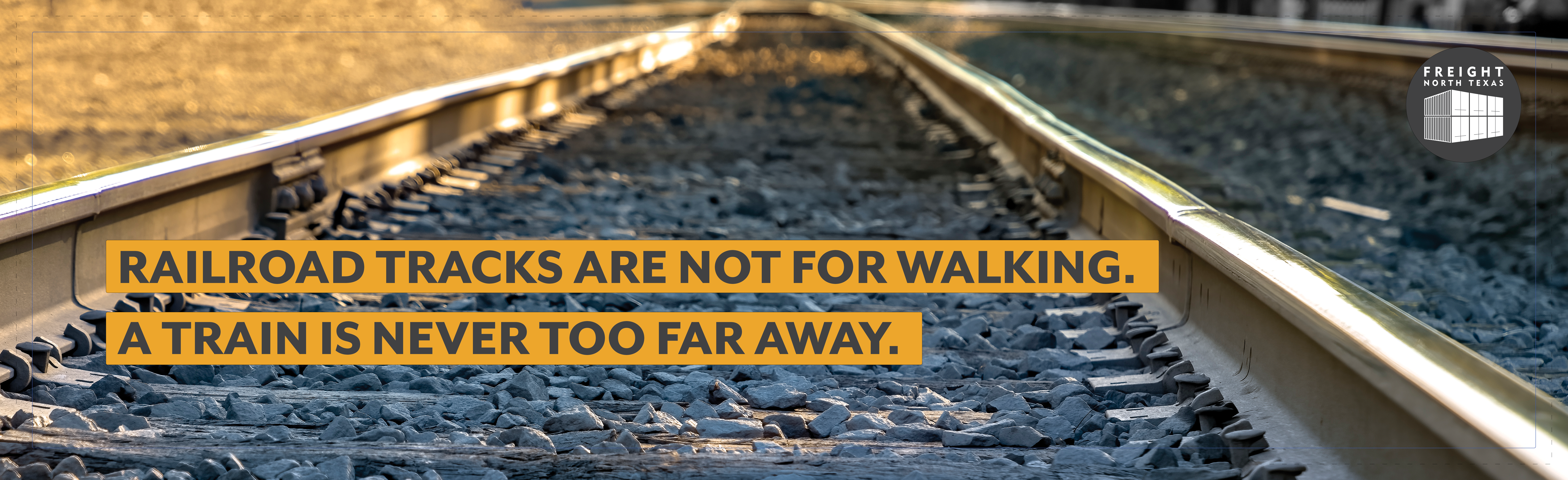 Close up of railroad track with the phrase railroad tracks are not for walking- a train is never too far away