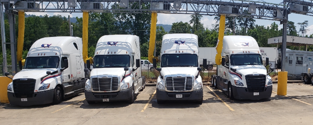 This is a photo of a line of white semi trucks