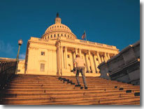 Image of a man walking up steps to the Capitol