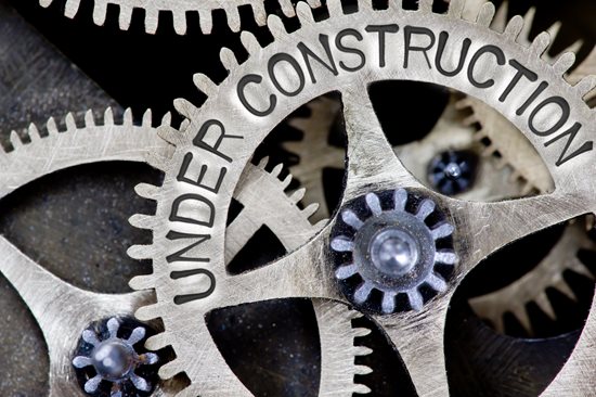 This is an image of cogs with the text on them reading "under construction"