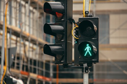 This is an image of a stoplight with a pedestrian walk sign lit up