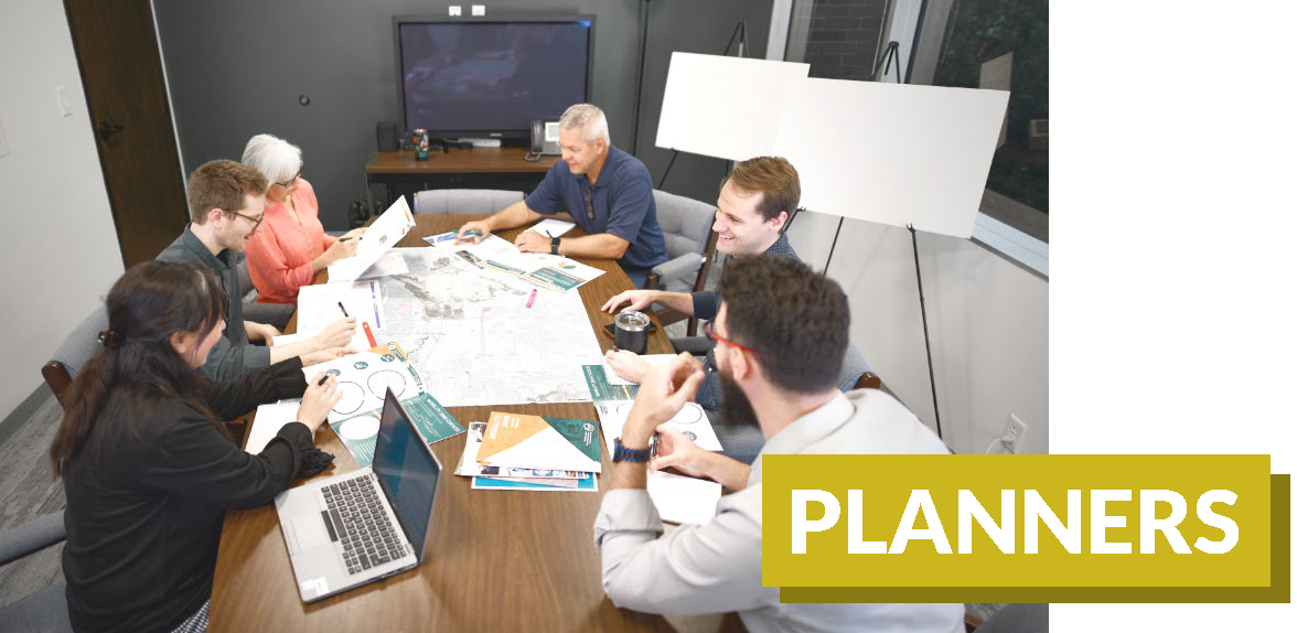 A group of government professional planners gathered around a table.