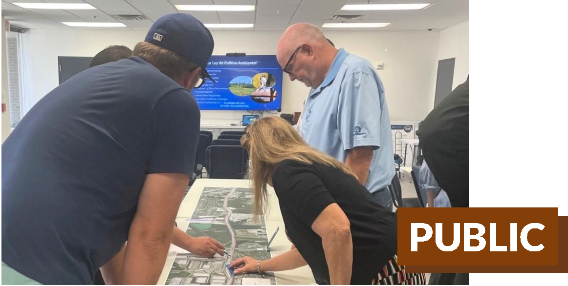 Residents reviewing a map at a public meeting.